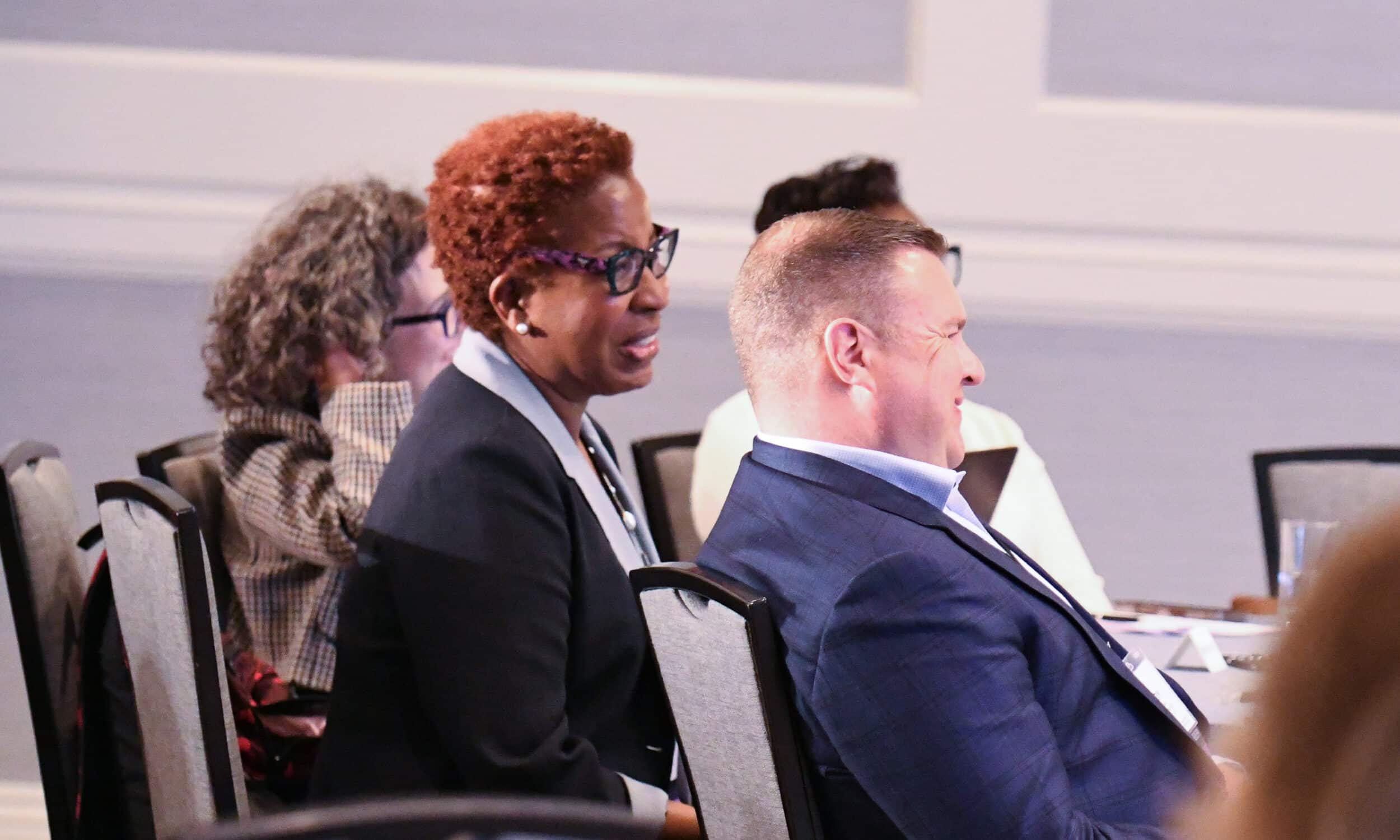 Attendees sharing a laugh during a session